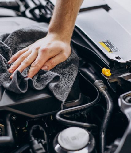 man polishing car inside at car service