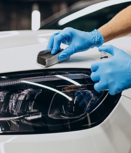 man working car detailing and coating car